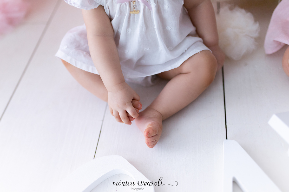 A foto mostras apenas os pés e as mãos de uma das meninas. Ela está segurando um dos pés com a mão
Ensaio Smash The Cake
Fotografado por Mônicas Fotografia em Maringá-PR