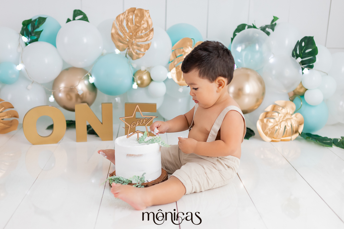 No cenário de Smash, o bebê está sentado de lado com o bolo entre as pernas. Ele está com a mão no bolo
Fotografado por Mônicas Fotografia em Maringá-PR