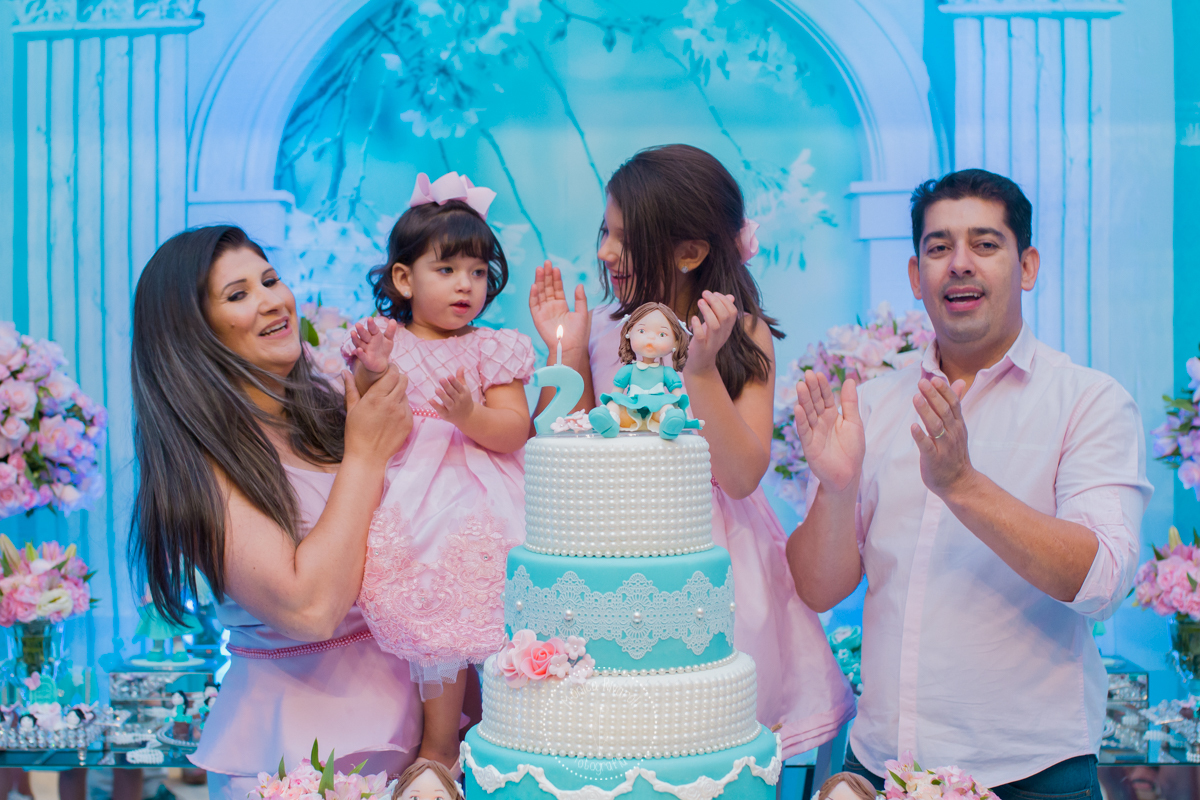 É a hora do parabéns, a Lívia esta no colo da mamãe, do ladinho da irmã 