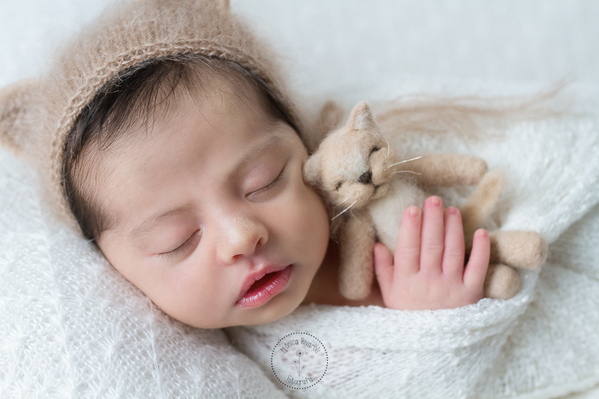 Miguel dormindo abraçando o gatinha e com uma toquinha de gatinho