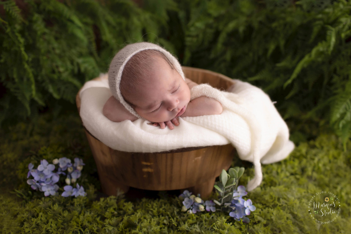 Foto de bebê no jardim realizado no nosso studio fotográfico em São Paulo SP Vila Leopoldina, o recém-nascido está dentro de um cesto com uma linda manta bege