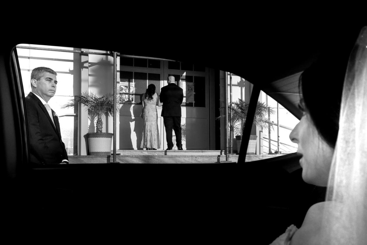 pai da noiva aguarda entrada da filha que observa a entrada do noivo em porta da igreja de casamento em Guaratinguetá foto erasmo ballot