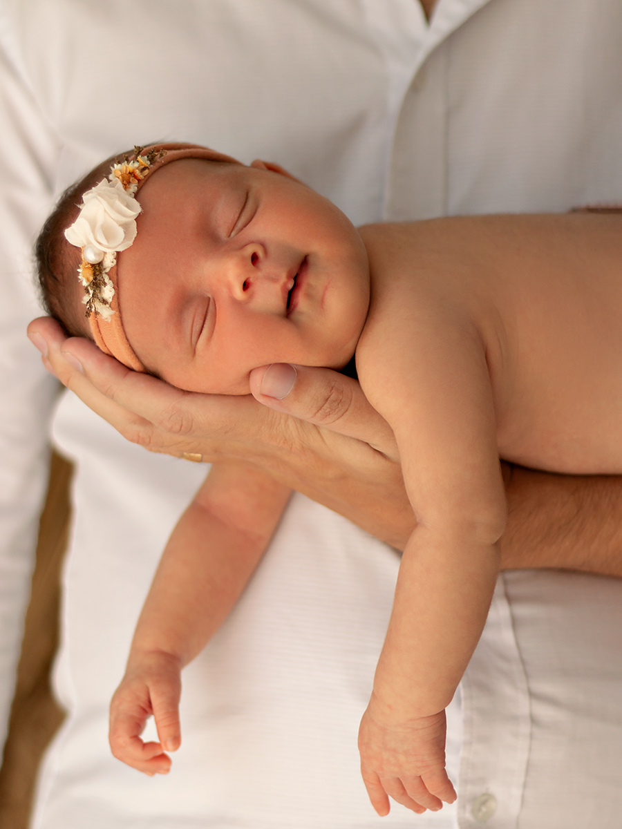 Foto de bebê recém-nascida nos braços do pai. Estúdio do bebê em natal/RN.