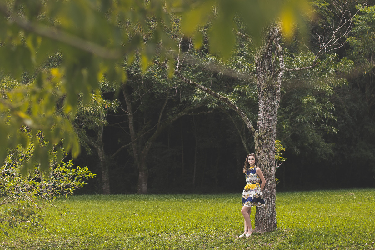 modelo recostada na árvore