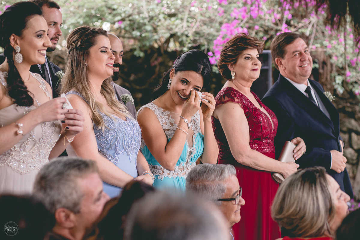 Fotografia de casamento feita no final de tarde pelo fotógrafo Guilherme Santos, madrinha emocionada no casamento ao ar livre em Botucatu.