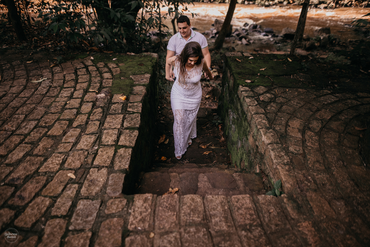 Fotografia de pré casamento feita no final de tarde pelo fotógrafo Guilherme Santos, casal de noivos caminhando no local da sessão pré casamento em Brotas, sessão na cachoeira.