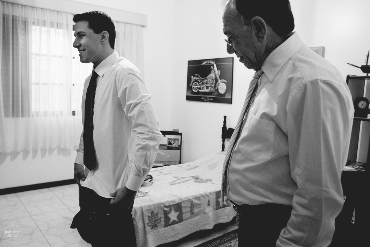 Fotografia de casamento pelo fotógrafo Guilherme Santos, noivo e seu pai se arrumando em casa para o casamento