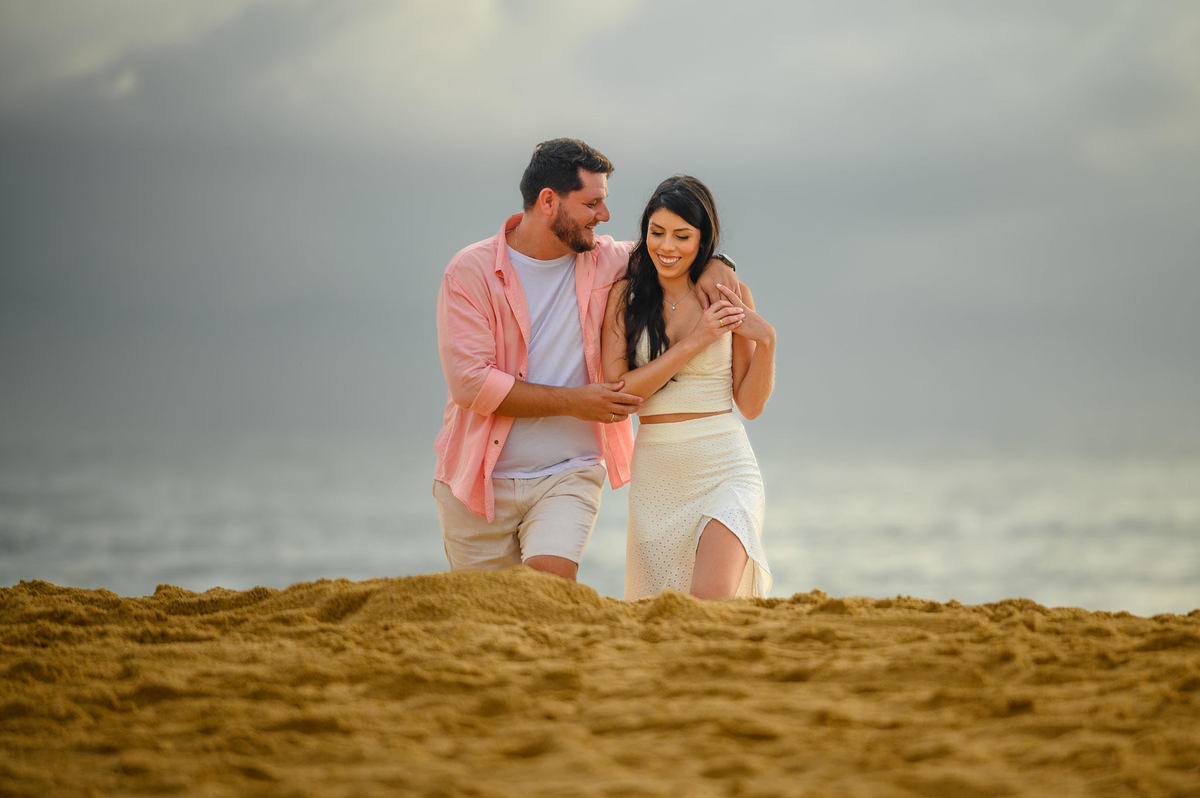 Casal em ensaio fotográfico na praia antes do nascer do sol