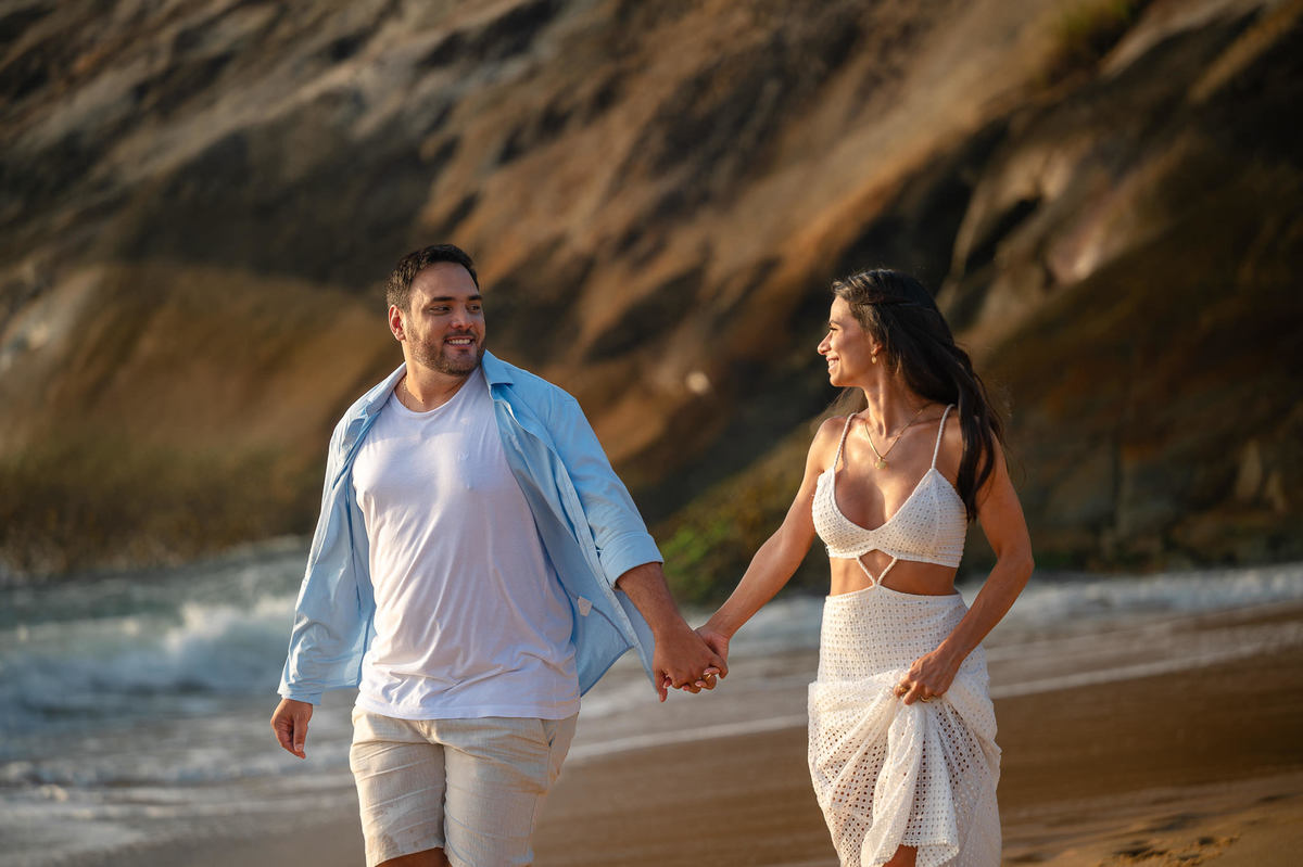 ensaio fotográfico de casal balneário camboriú sc casal caminhando de mãos dadas na praia do estaleirinho