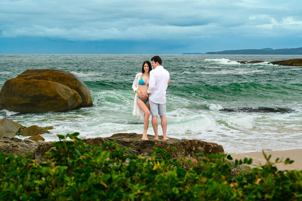 Fotografia de gestante na praia do Estaleirinho em Balneário Camboriú com céu nublado