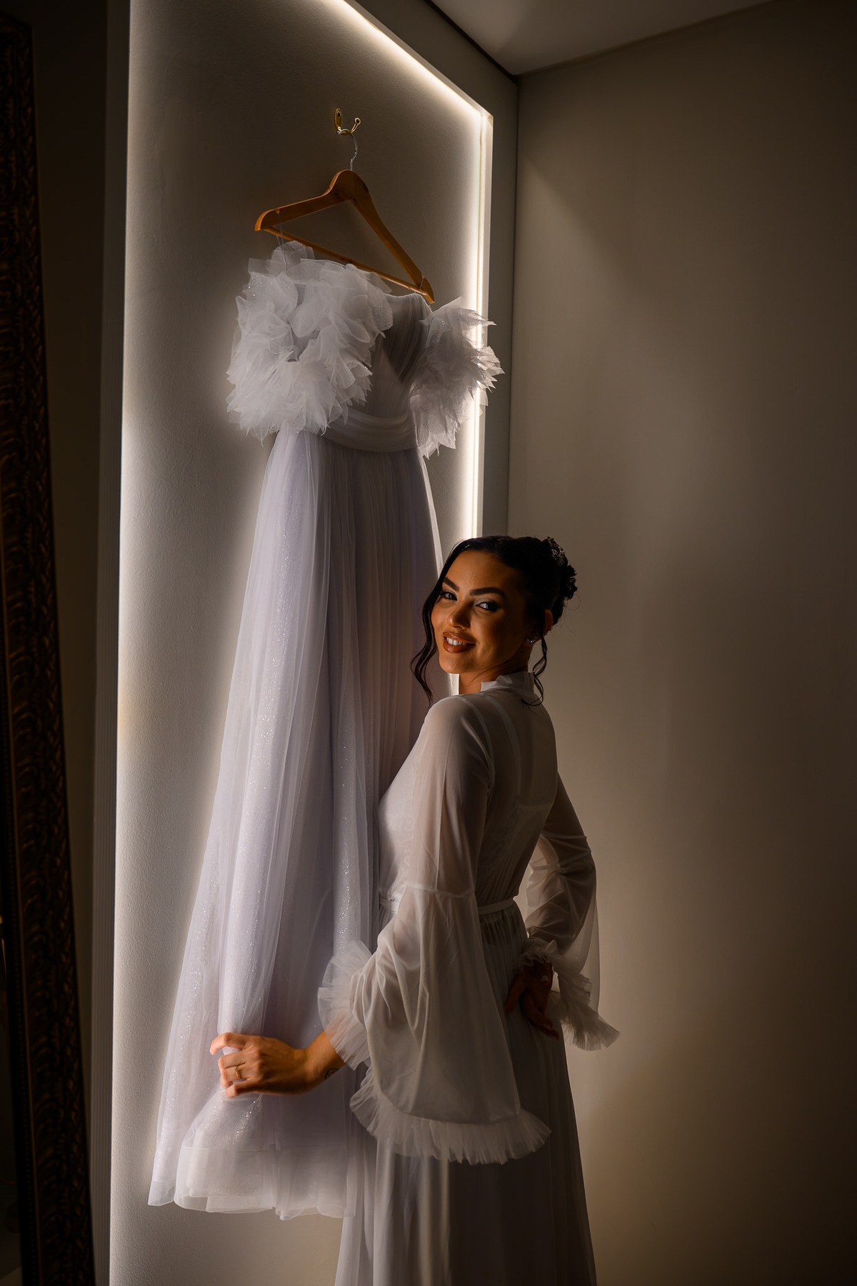Noiva ao lado do vestido antes da cerimônia de casamento

