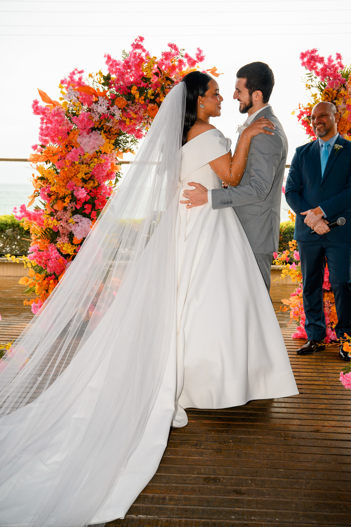  Casal diante do altar floral após a troca de alianças