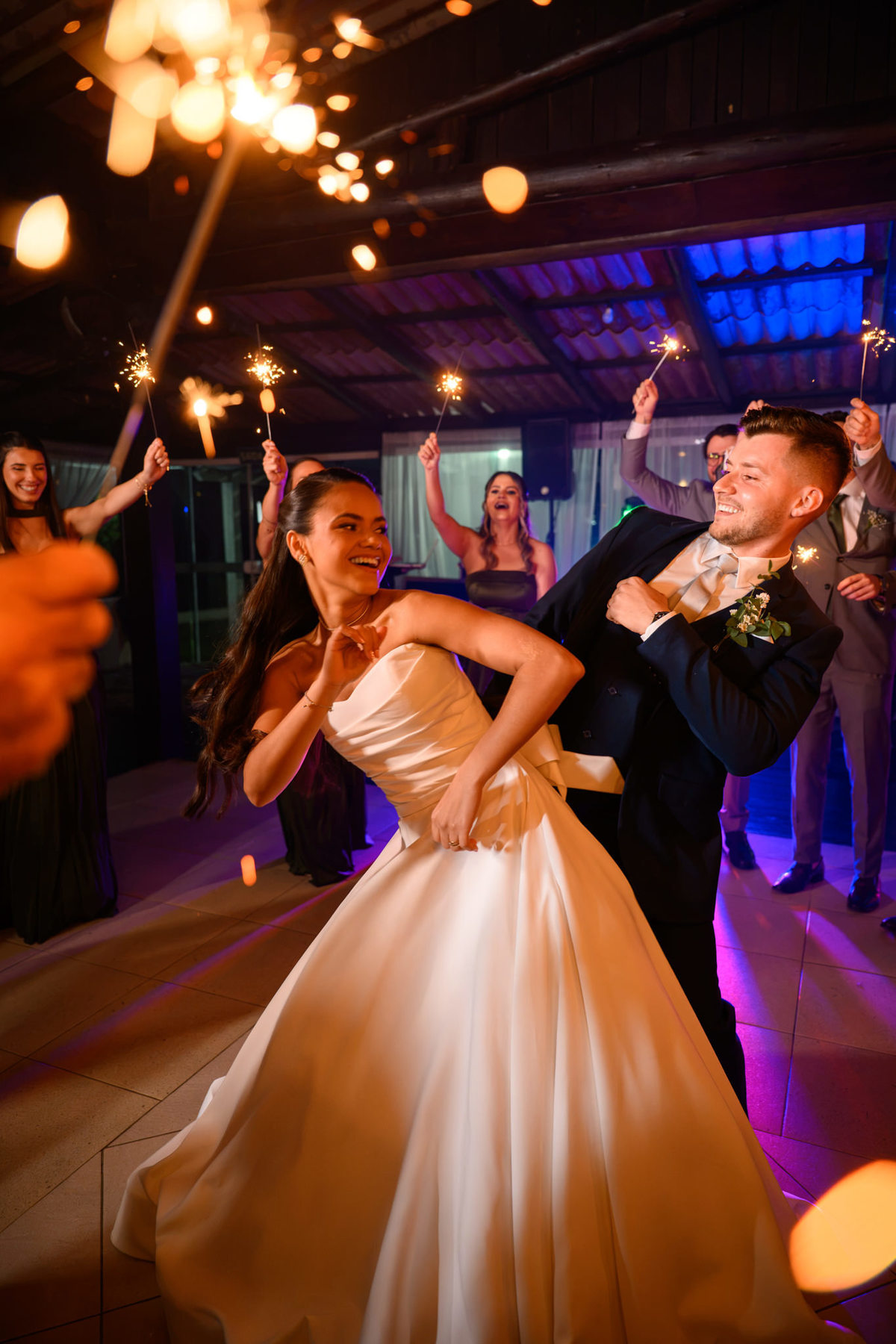 Casal dançando com luzes em primeiro plano na festa

