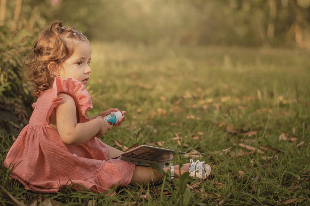 foto menina na natureza segurando brinquedo