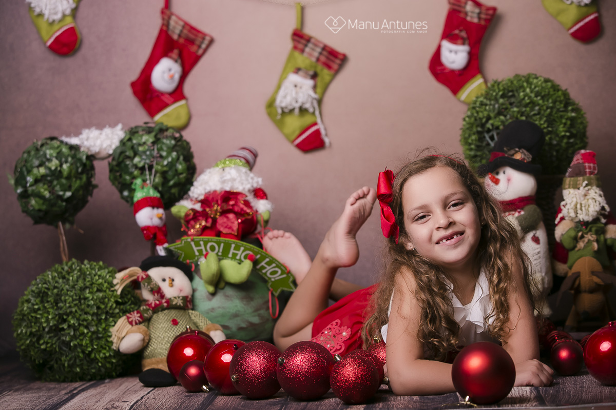 menina deitada com bolas vermelhas