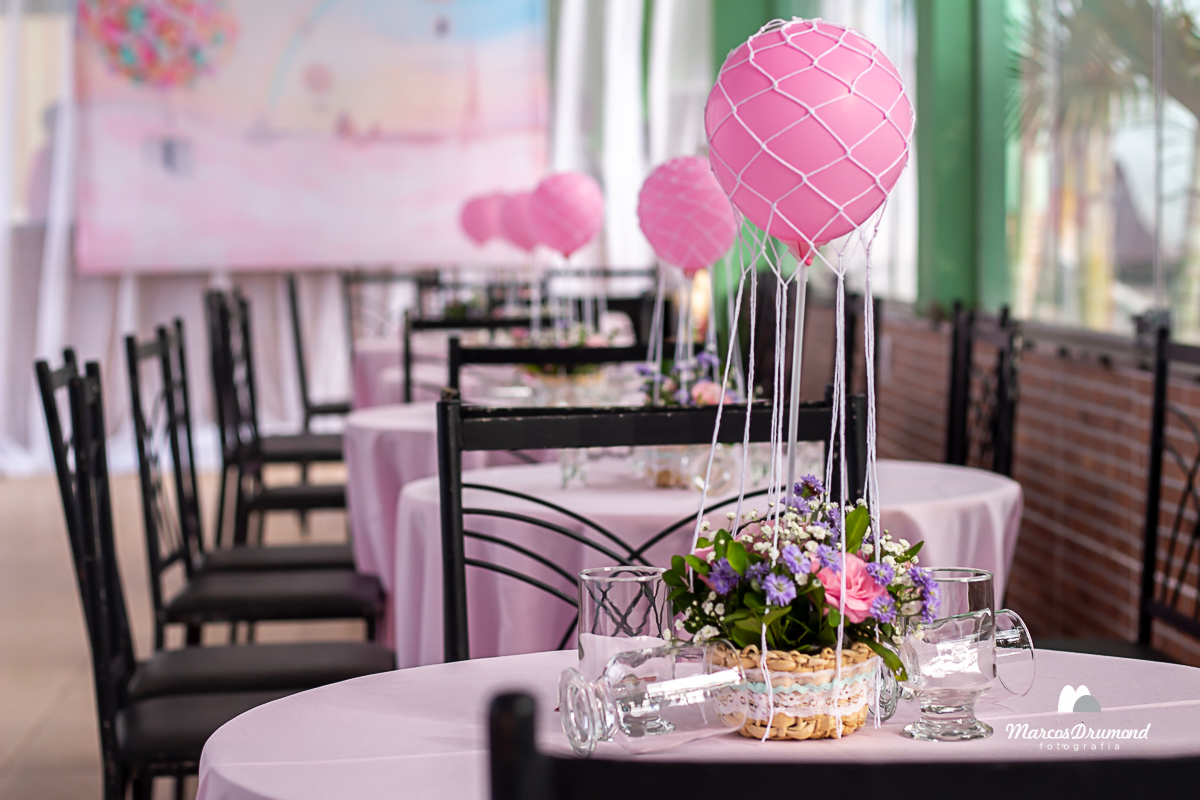 Mesa com enfeites de aniversário de 1 ano de aniversário com balão sobre ela, copos e enfeites