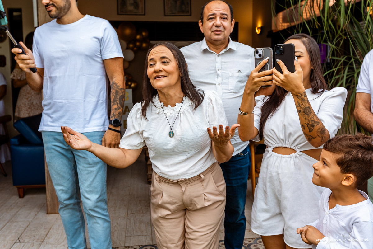 Fotografia de chá revelação intimista em casa, primeiro filho de Fernanda e Samuel, revelação da chegada de Maria com a família reunida, emoção, momentos espontâneos e fotografia documental de família em Natal/RN, fotógrafa de chá revelação.