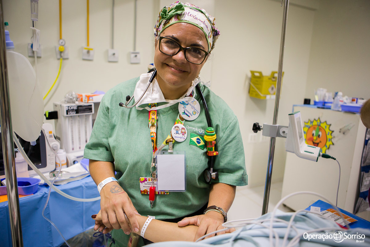 anestesista e voluntaria da Operação Sorriso mostrando a sua tatuagem com logo da ONG