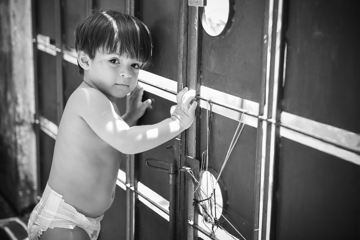 criança encostada no portão