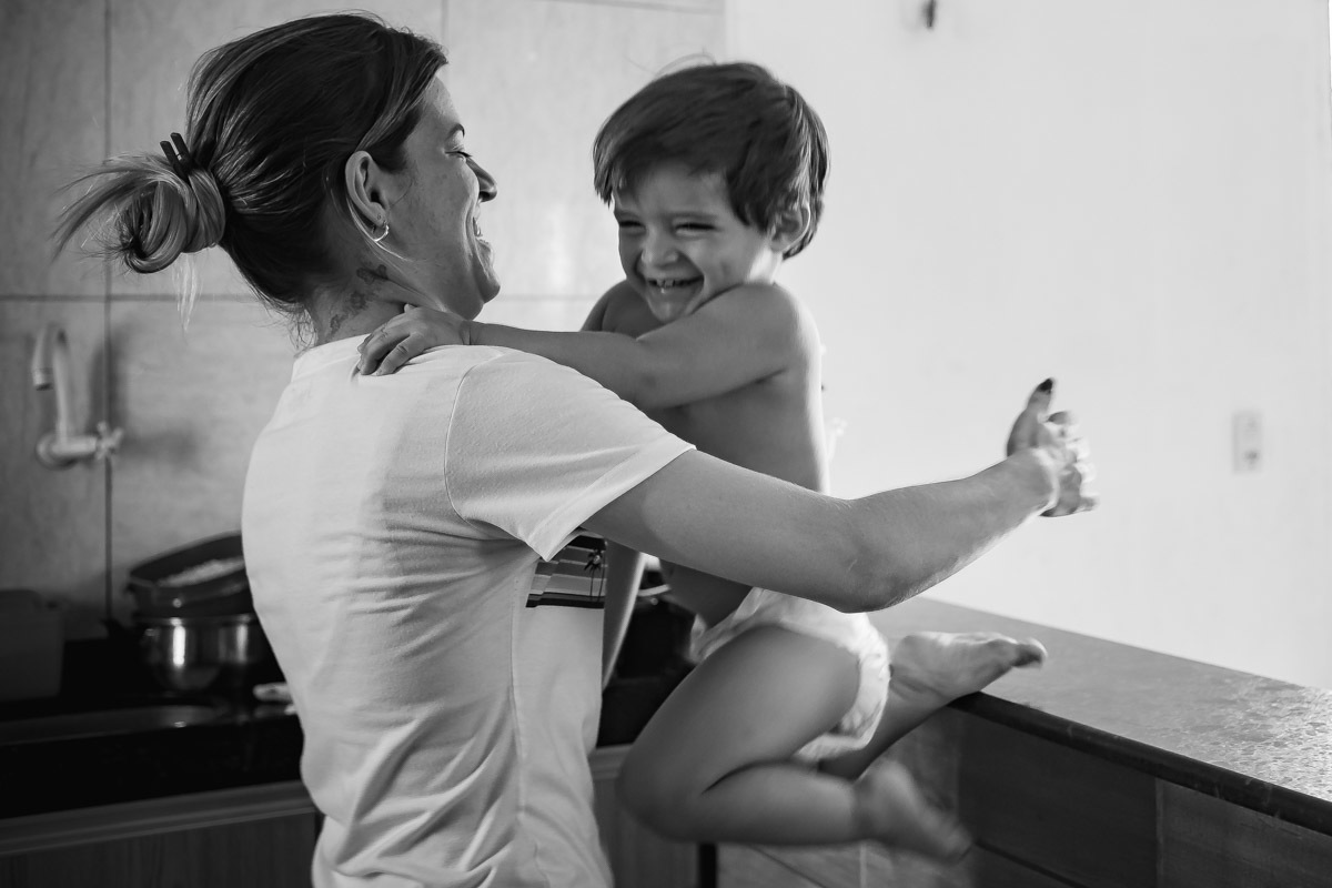 criança pulando de balcão para os braços da mãe