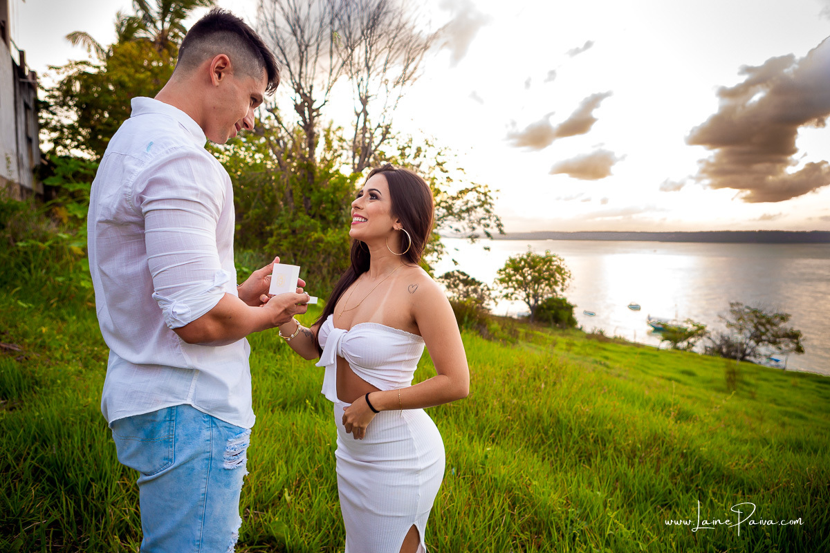 Mulher olhando homem que esta com aliança na mãos e sorrindo na praia de Pipa