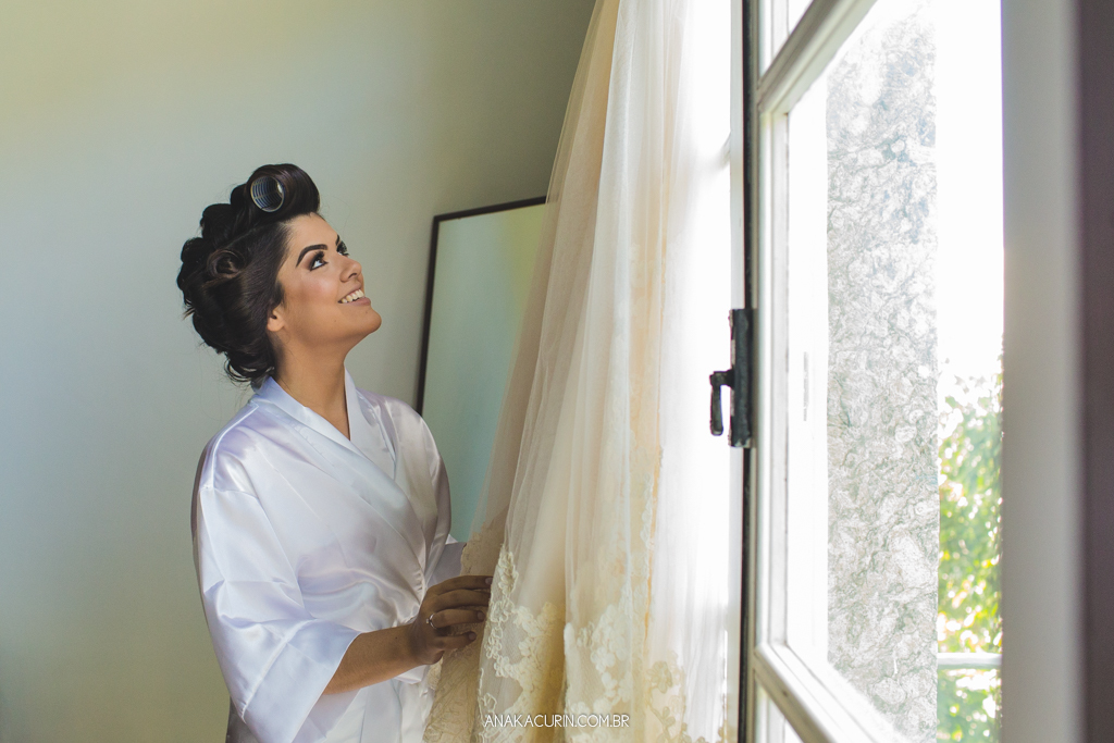 Noiva apreciando seu vestido de noiva, sorrindo