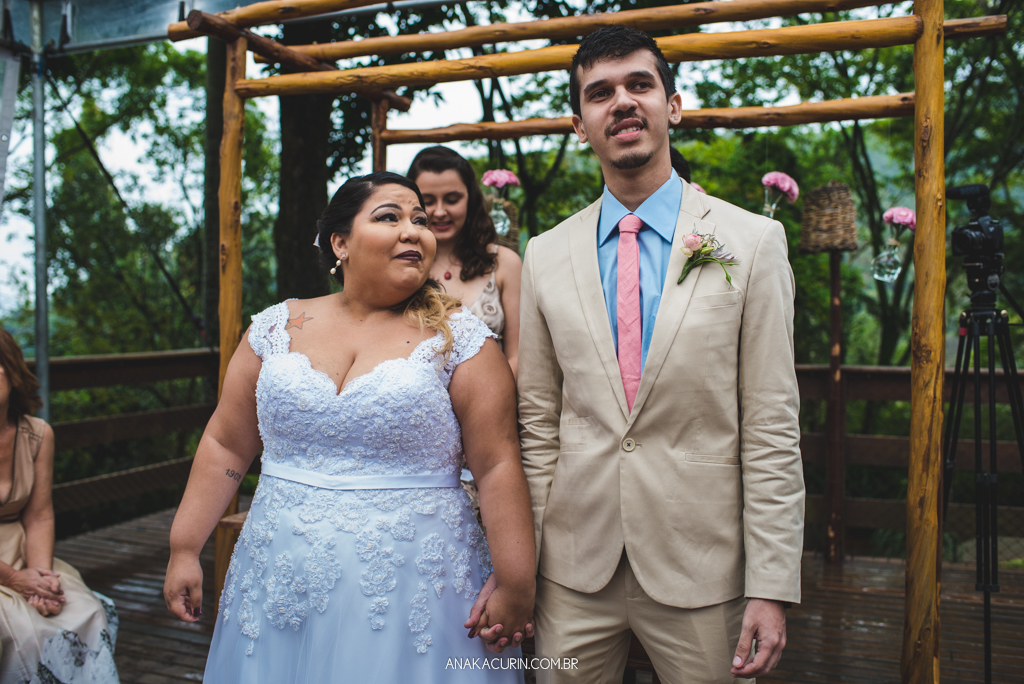 Noiva olha para noivo emocionada em cerimônia de casamento