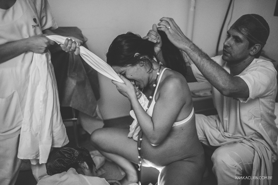 Parto natural hospitalar de Sofia, que aconteceu na Perinatal de Laranjeiras e teve a fotografia feita por Ana Kacurin. Contrações do momento do expulsivo, gestante sustentada por um tecido.