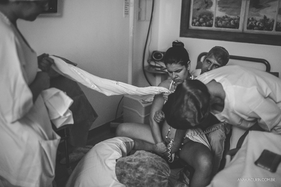 Parto natural hospitalar de Sofia, que aconteceu na Perinatal de Laranjeiras e teve a fotografia feita por Ana Kacurin. Gestante se toca e sente o bebê coroando.