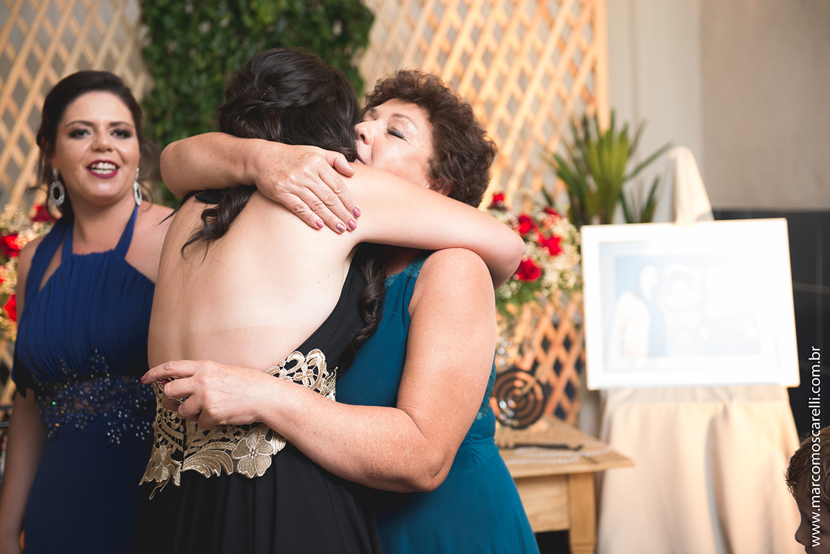 Formanda abraçando a sua mãe na entrada da recepção de formaura de Marketing