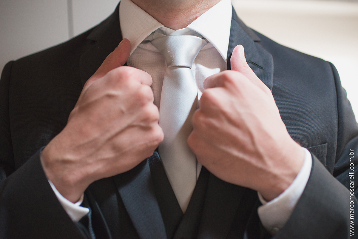 Noivo segurando o blazer durante o Making of antes do casamento. Foto por Marco Moscarelli