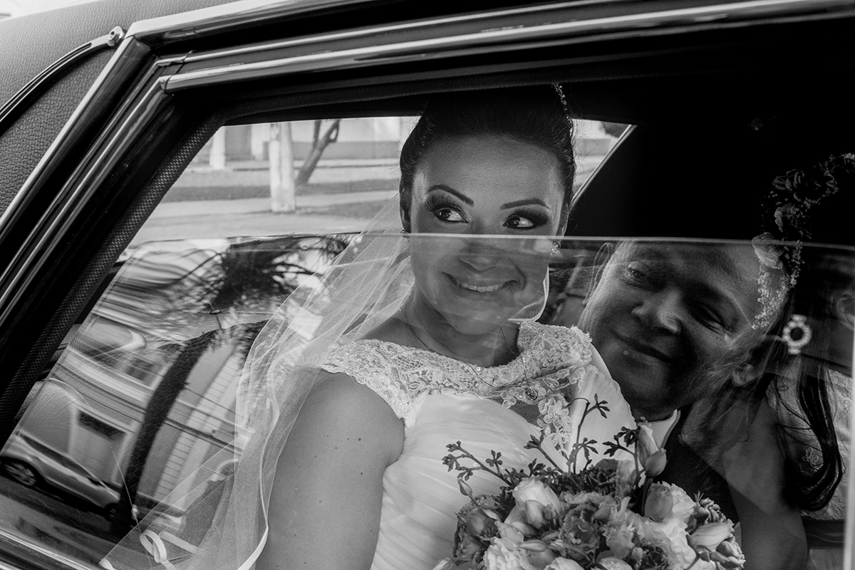Foto em Preto e Branco do detalhe do reflexo do pai da noiva no vidro do carro momentos antes do casamento. Foto por Marco Moscarelli