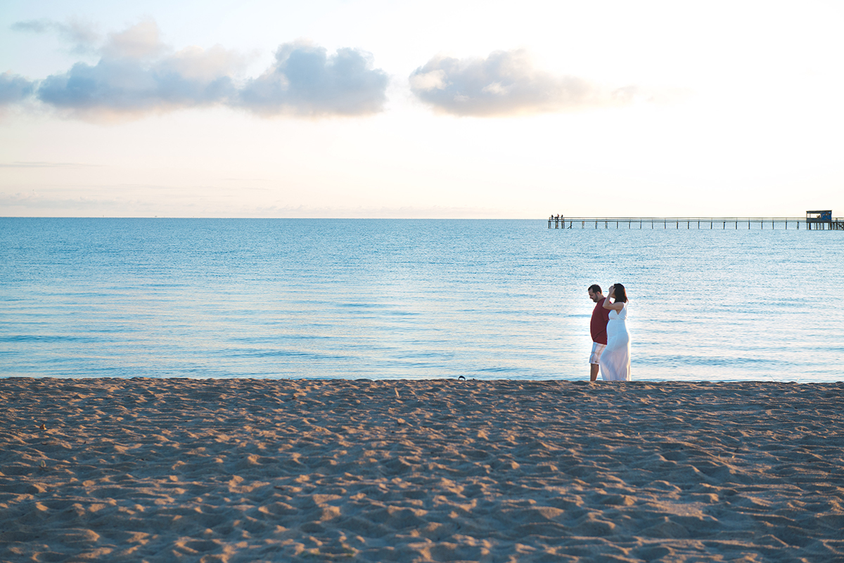 Noivos caminhando na areia da pria do laranjal durante o seu pré-wedding. Foto Por Marco Moscarelli