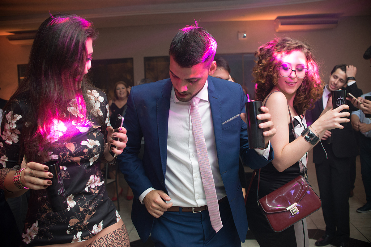 Formando em direito em Pelotas se divertindo com suas convidadas durante a sua recepção de formatura. Foto por Marco Moscarelli Fotografo.