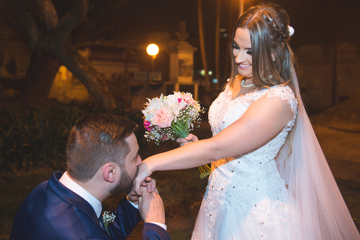 Noivo de joelhos beijando a mão da noiva logo após a cerimônia de casamento. Foto por Marco Moscarelli Fotografo.