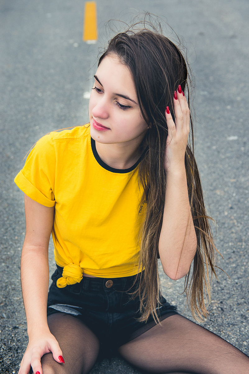 Debutante sentada no meio da rua durante seu ensaio fotográfico de 15 anos. Foto por Marco Moscarelli Fotografo.