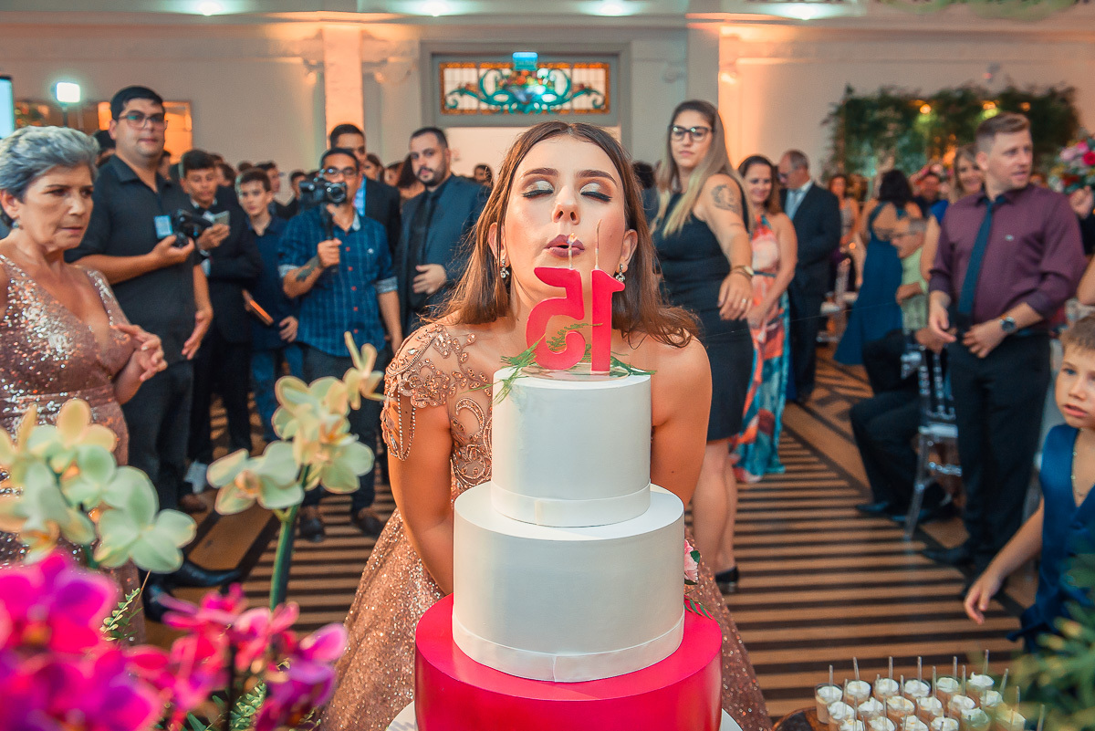 Debutante apagando as velas do bolo de 15 anos logo após os parabéns em sua em sua  festa de 15 anos em jaguarão. Foto por Marco Moscarelli  fotografo pelotas.