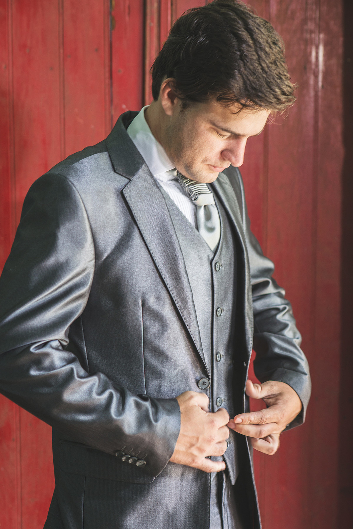 Detalhe do noivo abotoando a manga da camisa  para o casamento