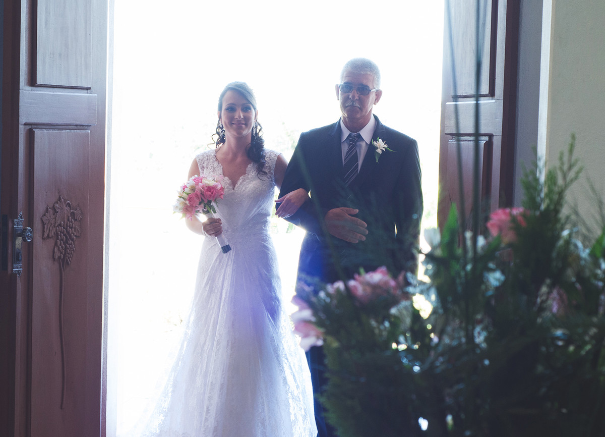 Entrada da noiva na irgeja acompanhada pelo seu pai.