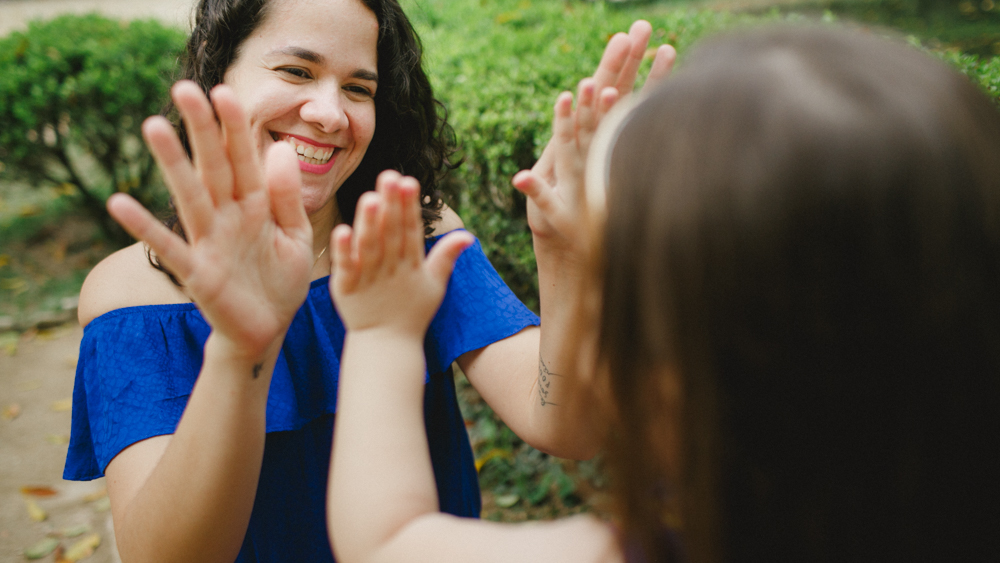 m&atilde;e e filha se divertem brincando durante ensaio fotogr&aacute;fico de fam&iacute;lia no jardim bot&acirc;nico do rio de janeiro