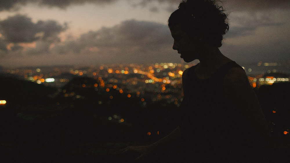 A arte de fotografar no contra luz do sol no Mirante Dona Marta | Rio de Janeiro - RJ, podemos ver a silhueta da Nathalia enquanto observa a cidade maravilho ao fundo.