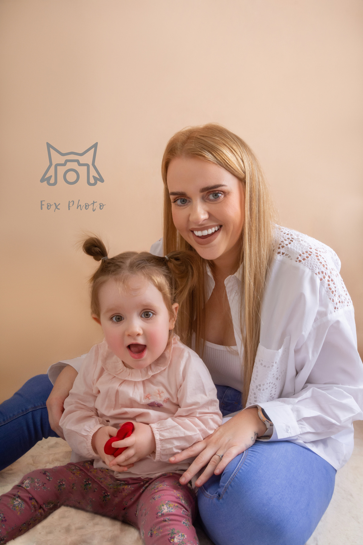 mom and daughert similings for the camera