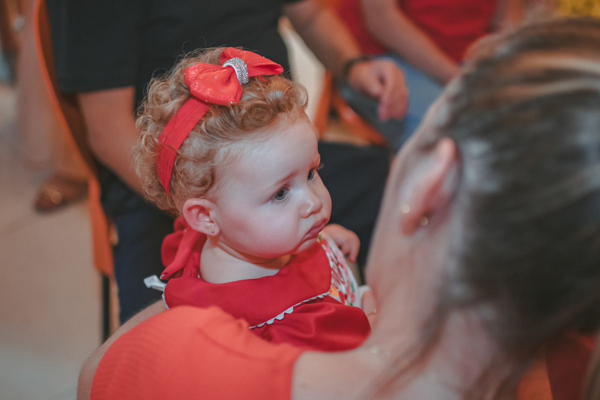 uma bebê observando uma mulher durante seu aniversário de 1 ano.