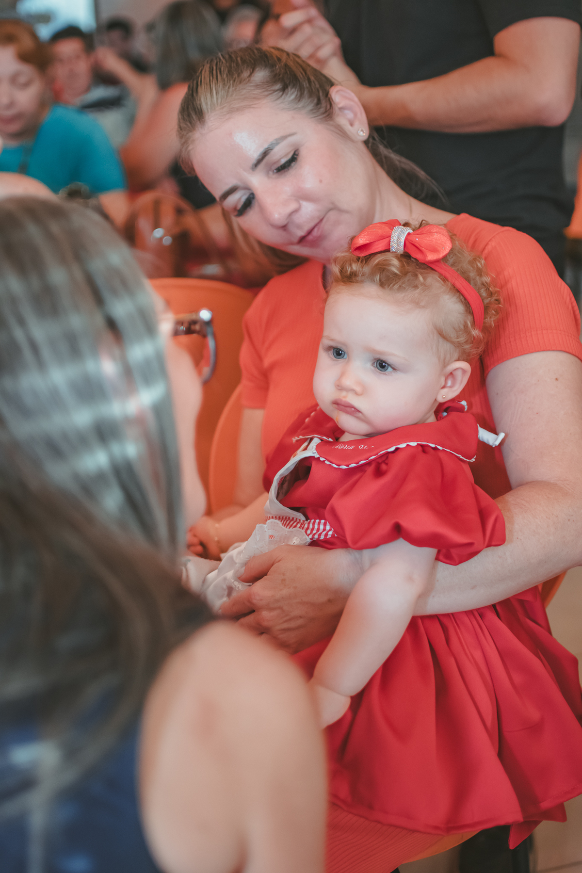 uma bebê observando uma mulher durante seu aniversário de 1 ano.