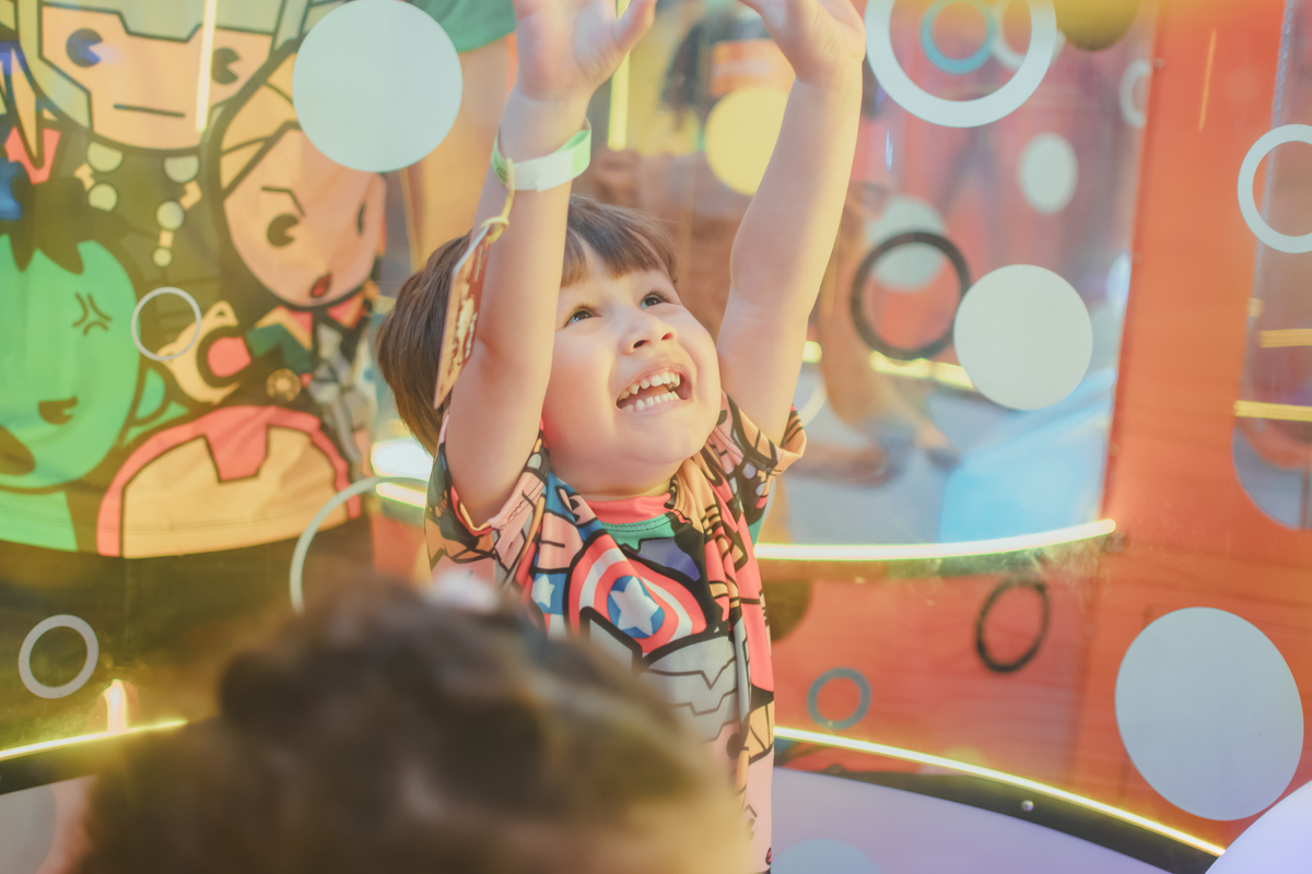 um menino brincando de pegar bolinhas em um brinquedo do Playcenter Family durante a sua festa de aniversário.
