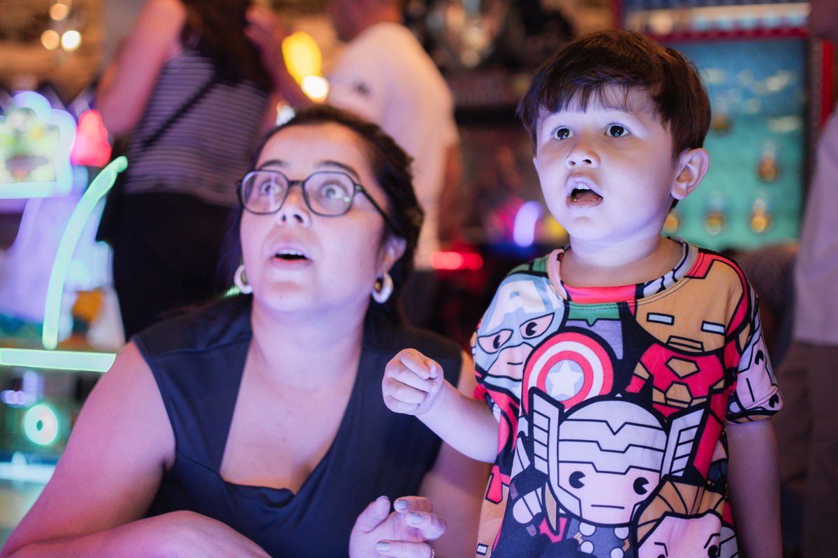 Um menino com sua mãe, brincando de boliche no Playcenter family durante sua festa de aniversário.