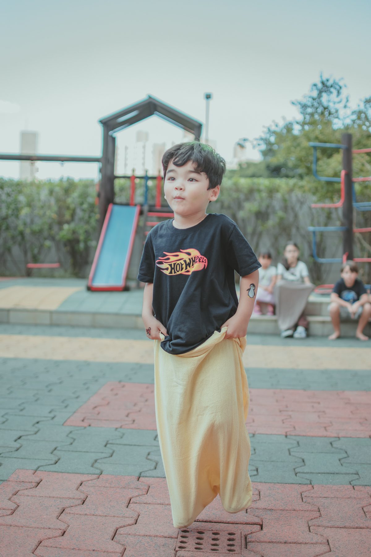 Um menino brincando de pular com  o saco, durante seu aniversário de 4 anos.