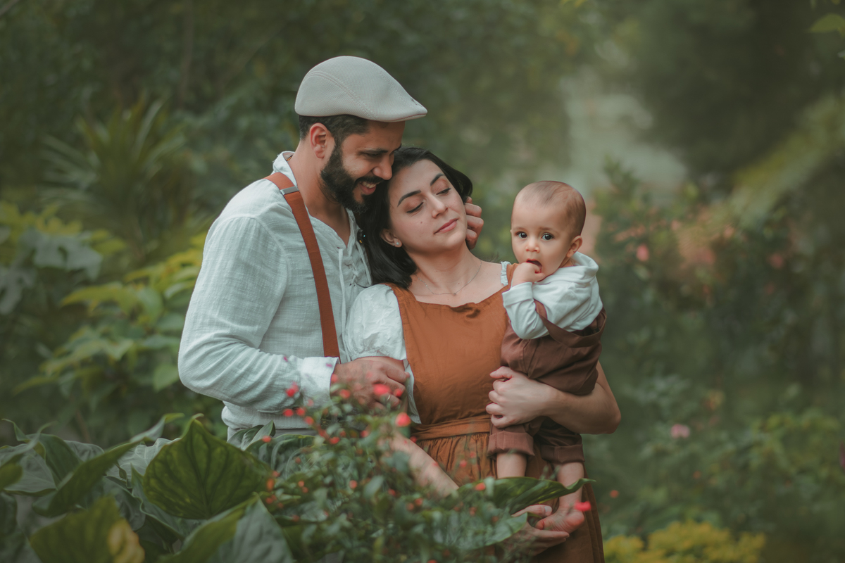 Uma família vestida de campnesa durante um ensaio de um ano em meio a natureza.