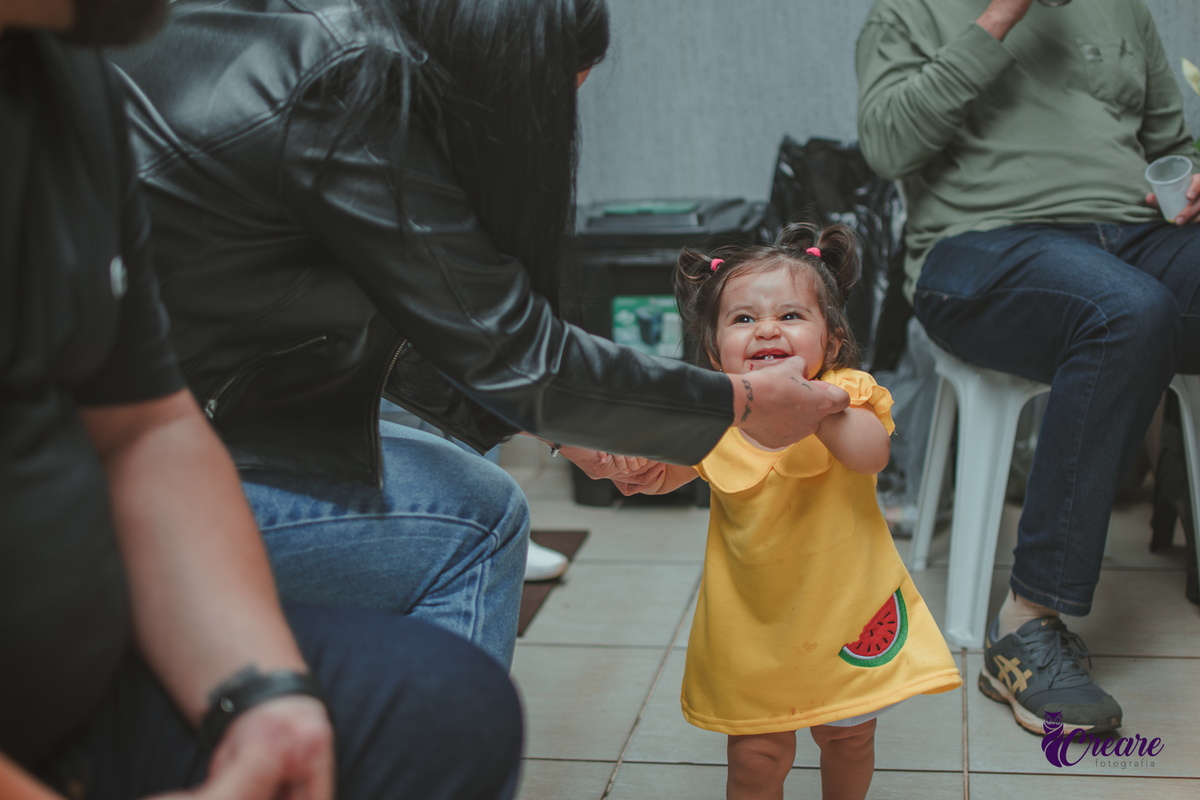 Uma bebê brincando em seu aniversário em casa.