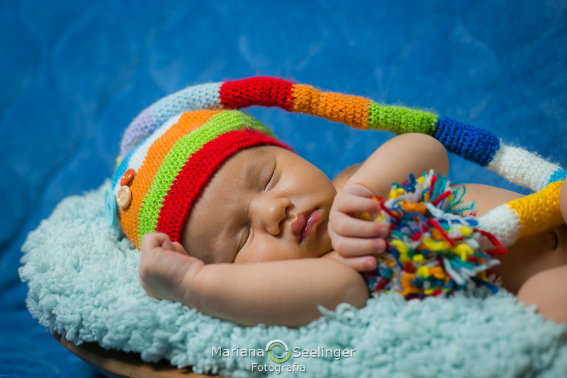 com touquinha colorida Francisco posa em seu ensaio newborn por Mariana Seelinger em Niterói - RJ